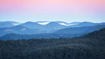 mountains and fog with a pink sky over brisbane water national parkの写真素材