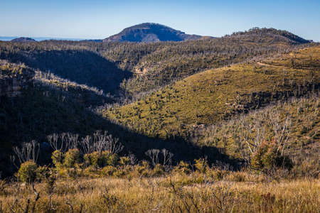 Mounds with light and shadows in the blue mountainsの写真素材