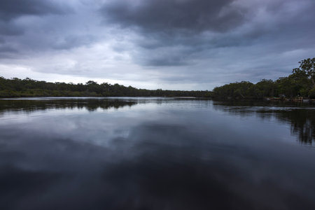 dusk over wooli wooli river running through a body of water in nsw australiaの写真素材