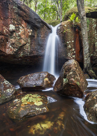 hidden waterfall and rocks in brisbane water national park nsw australiaの写真素材