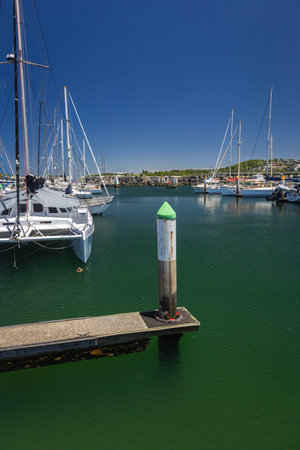 wharf and yacht boats in water at coffs harbour nswの写真素材