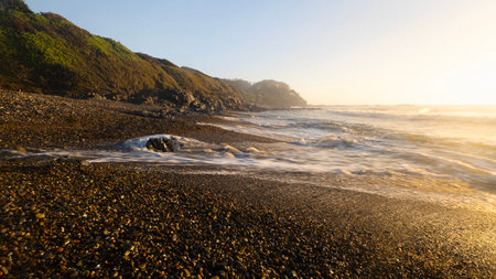 wave on pebbles at rocky beach in Minnie Water NSW Australiaの写真素材