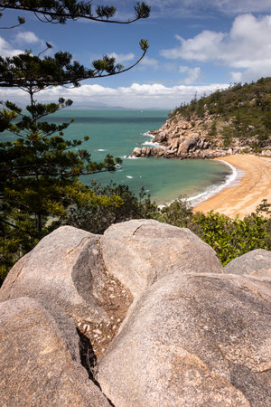 a close up of a rock next to a body of water at Arthur Bay on Magnetic Islandの写真素材