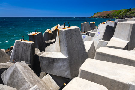 stone blockades on wharf at coffs harbour in australiaの写真素材
