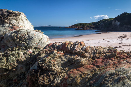 blue water between rocks at beach on broughton island hawks nest nsw australiaの写真素材