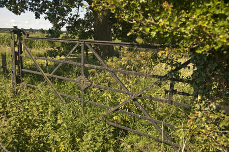  This very old farm gate is to be found in a field edge next to the church of St. Maryの写真素材