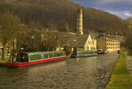 Canal barges on the Rochdale Canal, in the town center of Hebden Bridge, Yorkshire  England のeditorial素材