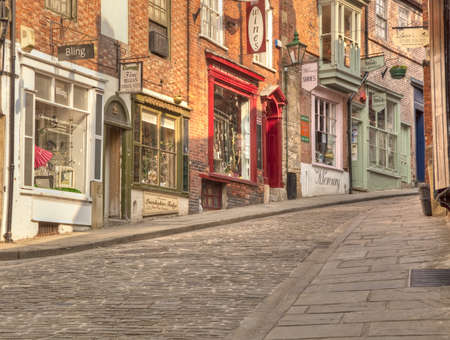 Quaint colourfull shops sell a range of trendy wares on the Steep Hill area close to Lincoln Cathedral のeditorial素材