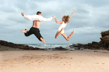 Young beautiful couple having fun flirting together at the beachの写真素材