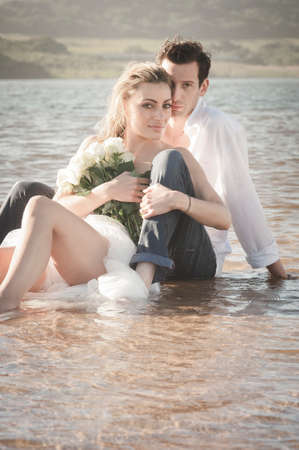 Young beautiful couple hanging out together at the beachの写真素材