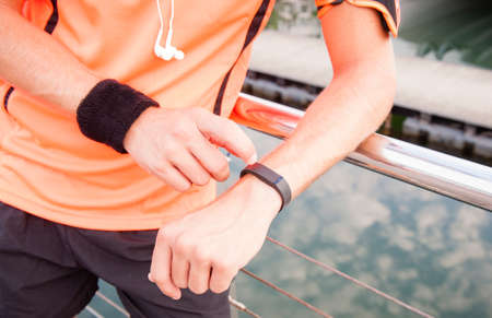 Close up of guy using wearable fitness gearの写真素材