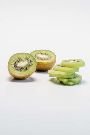 Kiwi fruit and slices on white background with copy spaceの写真素材