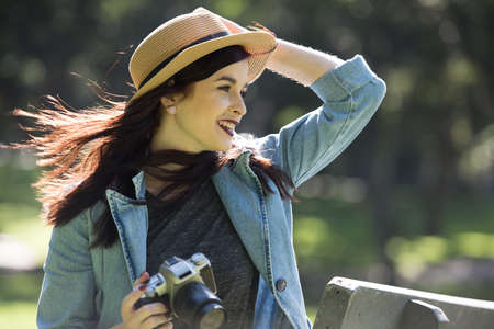Young happy traveler exploring surrounds with film camera