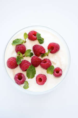 Red Raspberries in bowl of Yoghurtの写真素材