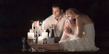 Couple at a candle lit ceremony together.の写真素材