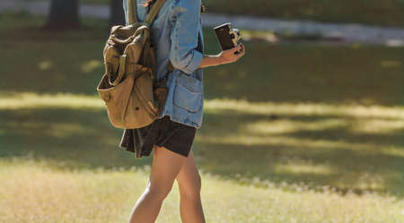 Young happy traveler exploring surrounds with film cameraの写真素材