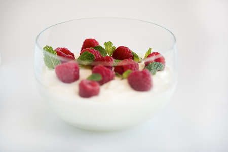 Red Raspberries in bowl of Yoghurtの写真素材