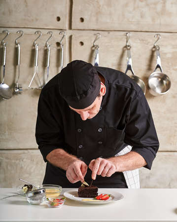 Restaurant hotel private chef preparing desert chocolate cakeの写真素材