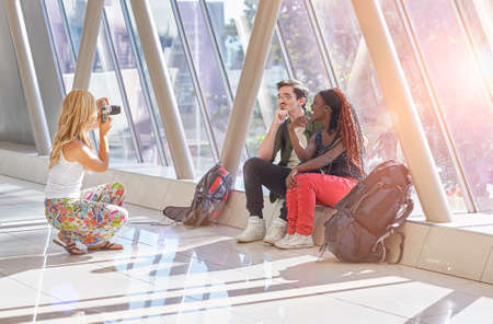 Travelling friends taking photos of eachotherの写真素材
