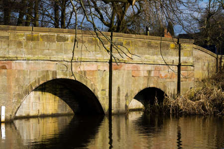 View of an old bridge crossing a lakeの写真素材