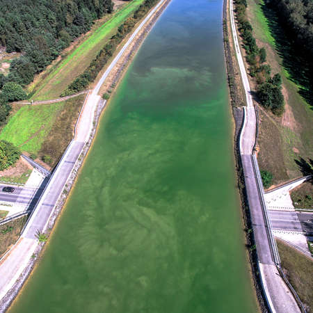 Aerial photo of a bridge with a canal over a streetの写真素材