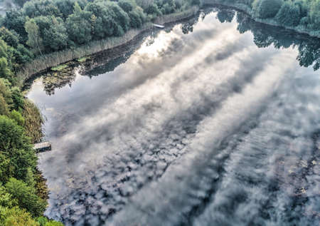Aerial photograph with drone, morning reflection of the clouds in a pondの写真素材