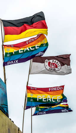Hamburg, Germany, December 10th 2017: Flags of the soccer club st paul and the colorful flag in the wind at the harbor.のeditorial素材