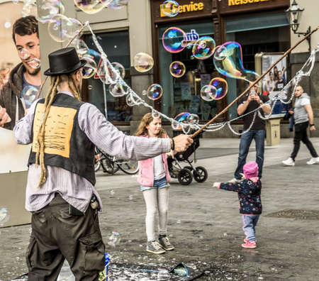 Leipzig, Saxony, Germany - October 21 2017: Street artists earn a few coins through large soap bubbles in the pedestrian zone of Leipzigのeditorial素材