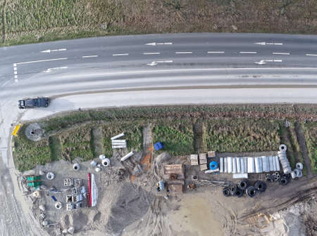 Aerial photograph of the material store for canal construction work on the construction site of a new development area, photographed with the droneの写真素材