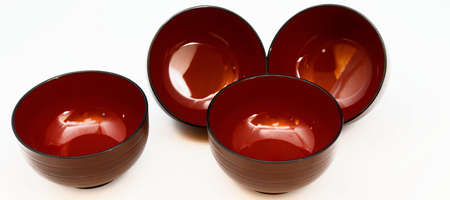 Still life of four Japanese lacquer bowls for miso soup or noodle soup, isolatedの写真素材