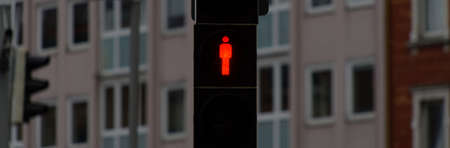 Standstill, red traffic light for pedestrians to stop sign and stop walking, background is blurred...