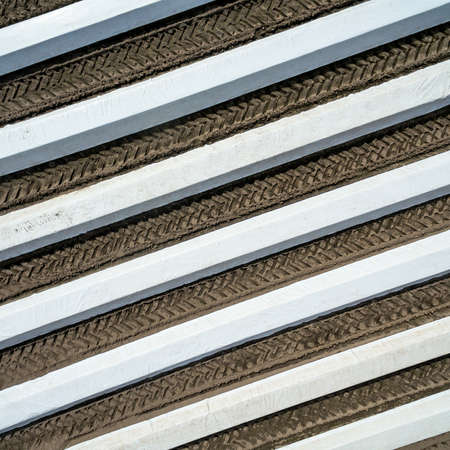 Asparagus varnish with asparagus plants (Asparagus officinalis) under a foil that is supposed to heat the soil and cause an early harvest, vertical aerial view of the asparagus varnish, made with drone.の写真素材