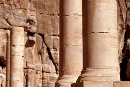 Roman columns next to the Nabataean amphitheatre in the rock town and necropolis of Petra , Jordan,...