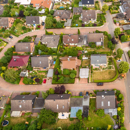Typical German new housing development in the flat countryside of northern Germany between fields and meadows, made with droneの写真素材
