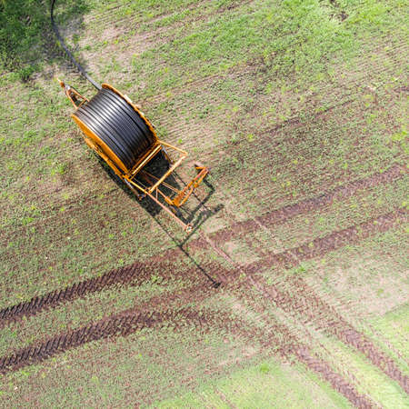 Aerial view of a huge hose cart used by the farmers to irrigate the arable land, Germany near Gifhorn, made with droneの写真素材