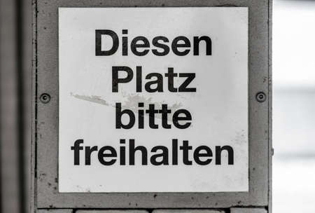 Dirty and ugly sign at a station with the German inscription "Keep this place clear", Germanyの写真素材