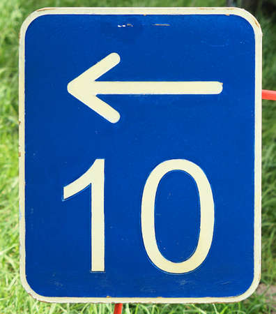 The number ten on a blue metal plate with a white arrow pointing to the left, germanyの写真素材