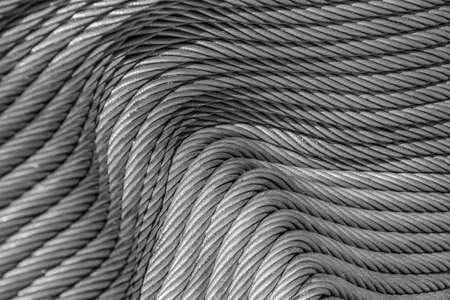 Pattern of a tightly folded new steel cable arranged in a wave-like parallel arrangement, texture and backgroundの写真素材