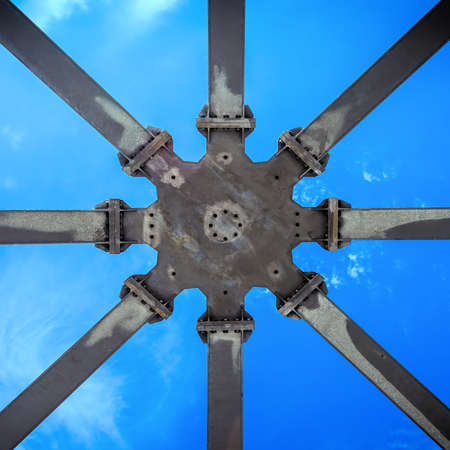 Star-shaped supporting structure taken from below against the blue sky, abstract geometric impression.の写真素材