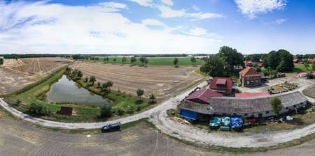 Aerial panorama in high resolution of a farm and a fishing pond.