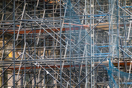 Complicated scaffolding consisting of many poles and struts inside a historic building