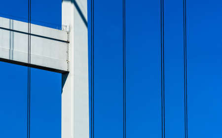 Abstract detail of the supporting structure of a bridge with piers and steel cablesの写真素材
