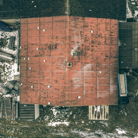 Abstract view from a vertical perspective of an old ugly annex on a shed, taken with the drone from the air.の写真素材