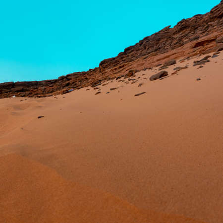 View from the holy mountain Jebal Barkal in Karima, Sudan perpendicular to the sand dune on the...