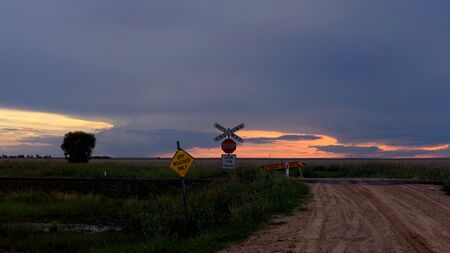 Railway crossing taken at sunset heading south from moreeの写真素材