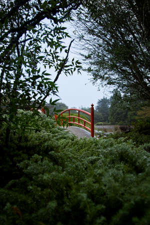 Low angle shot of a red bridge at the Japanese gardensの写真素材