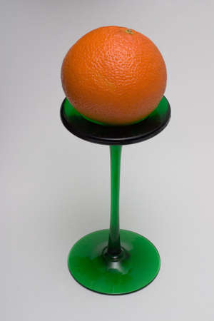Orange on a green glass standの写真素材