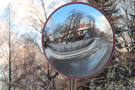 Through the Looking Glass: reflection of road and building in roadsign mirrorの写真素材