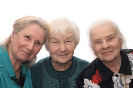 Three old women smiling, isolated on white backgroundの写真素材