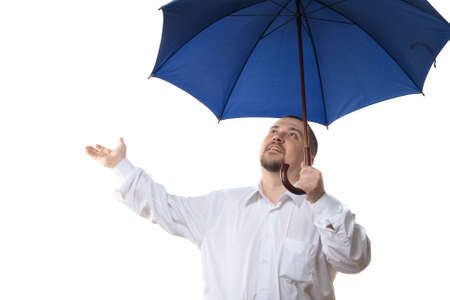 Man in white shirt under dark blue umbrella, isolated on white backgroundの写真素材